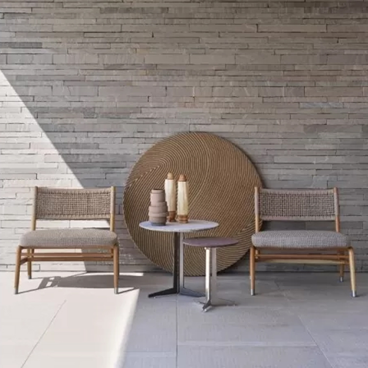loungestoelen langs een witte stenen muur met schaduw voorzijde